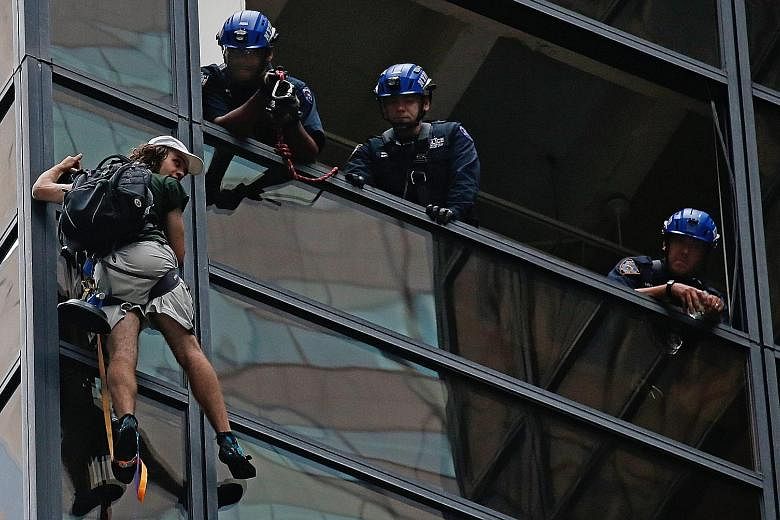Police officers communicating with the climber (left) who made his ascent up Trump Tower using suction cups. Some three hours after his ascent, they managed to grab him (below) and pull him to safety (right).