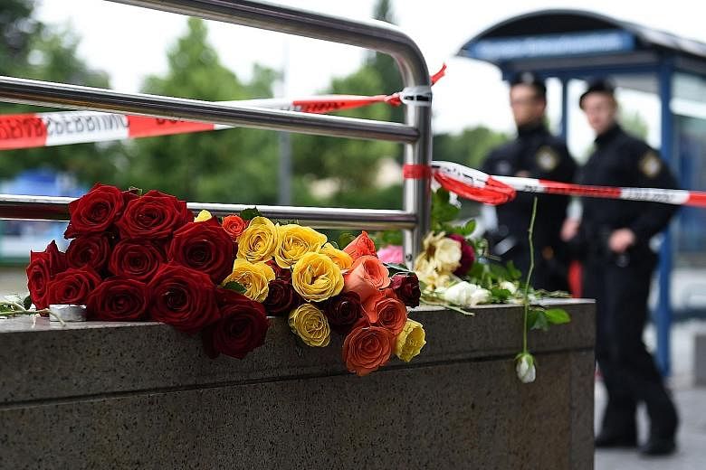 Flowers left in memory of victims of a shooting rampage near the Olympia mall in Munich last month. Germany has increased security measures in the wake of a series of terror attacks.