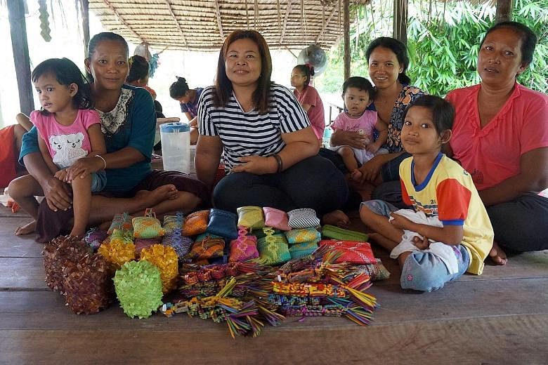 The Mah Meri people of Carey Island with the handicrafts they had brought for sale to Gerai OA. In the centre is Ms Maznah and on the far right is Ms Fauziah.