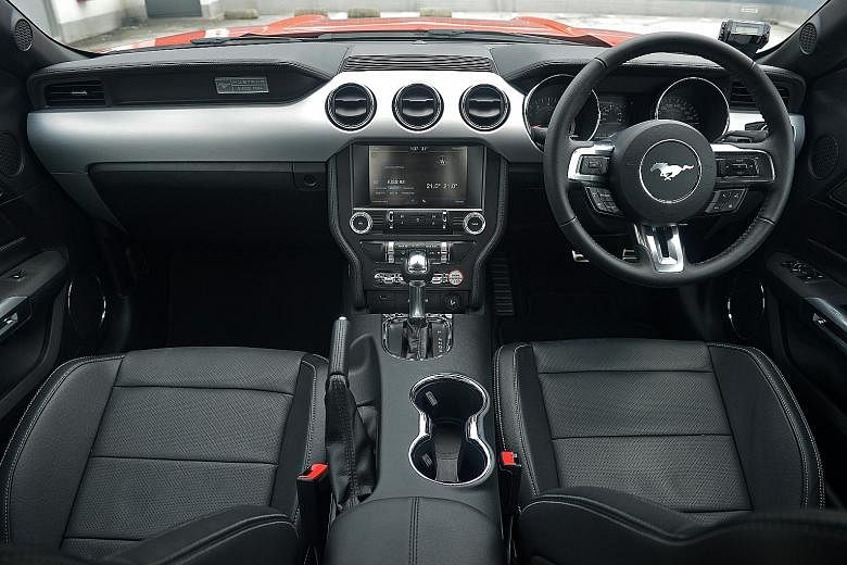 The cockpit (left) of the sixth-generation Mustang (far left).