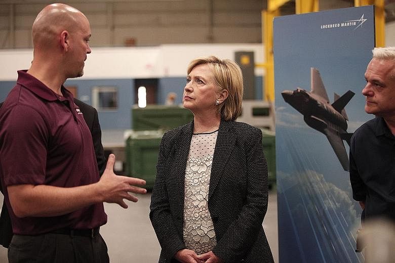 Mrs Clinton tours Futuramic Tool and Engineering before giving her speech in Warren, Michigan.