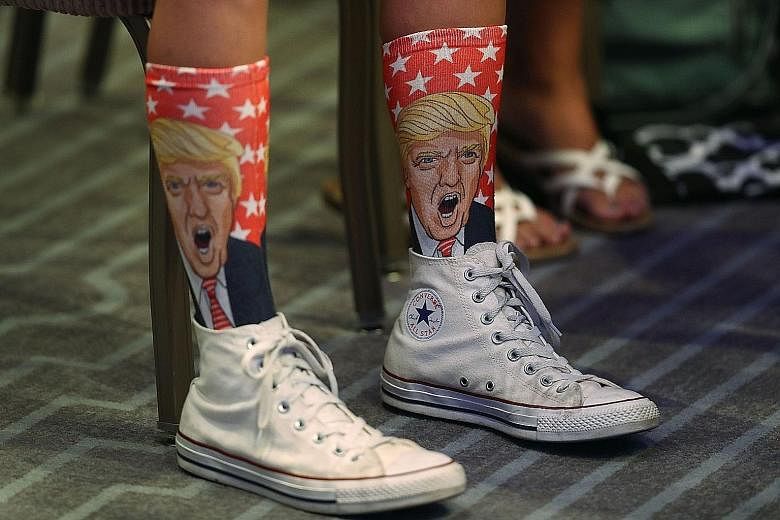 A supporter sporting Donald Trump socks as the Republican presidential nominee speaks at an address to the National Association of Home Builders at the Fontainebleau Miami Beach hotel on Thursday.