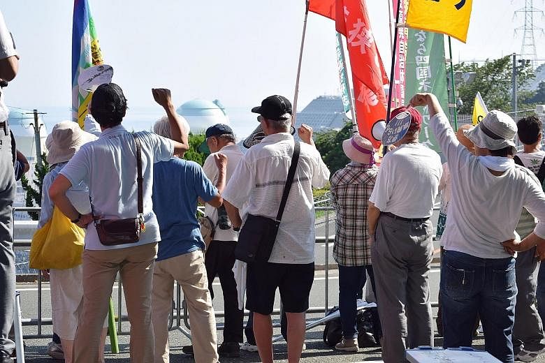 Residents and others opposing the restart of the Ikata nuclear reactor gathering near the plant in Ehime prefecture, about 700km south-west of Tokyo, yesterday. Opposition to nuclear power has seen communities across the country file lawsuits to prev