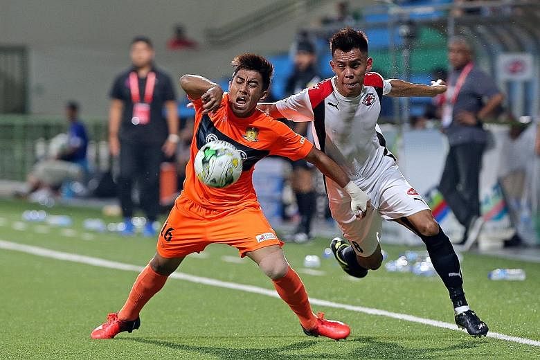 Hougang midfielder Raihan Rahman (left) held back by (right) Home United's Azhar Sairudin. Hougang United won 4-2, recovering from an early two-goal deficit to move to within one point of third-placed Brunei.