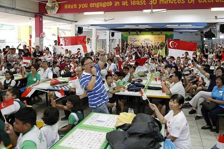 Juying Primary School pupils cheering along with teachers and parents, while waiting for the live telecast of Schooling's race yesterday. Parliamentary Secretary for Ministry of Education Low Yen Ling (in green T-shirt) was also present. "Do you want