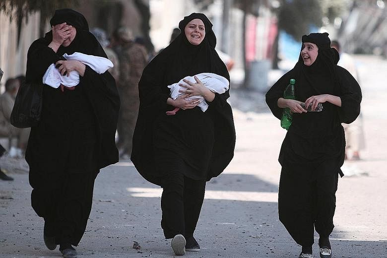 Women carrying newborn babies react with joy after getting evacuated by the Syrian Democratic Forces from Manbij. Losing the Syrian city is a big blow to the ISIS terror group, as it is of strategic importance, serving as a conduit for the transit of