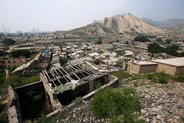 Abandoned houses on sinking land near a coal mine in Datong, Shanxi province, where the authorities plan to relocate 655,000 residents by the end of next year, at an estimated cost of $3.2 billion.
