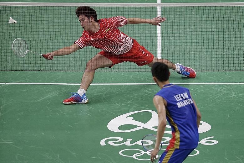 Derek Wong failing to return a shot against Malaysia's Lee Chong Wei during their Group A tie yesterday. The Singaporean shuttler fell to the world No. 1 in straight games, losing 18-21, 8-21, before hinting at possible retirement.