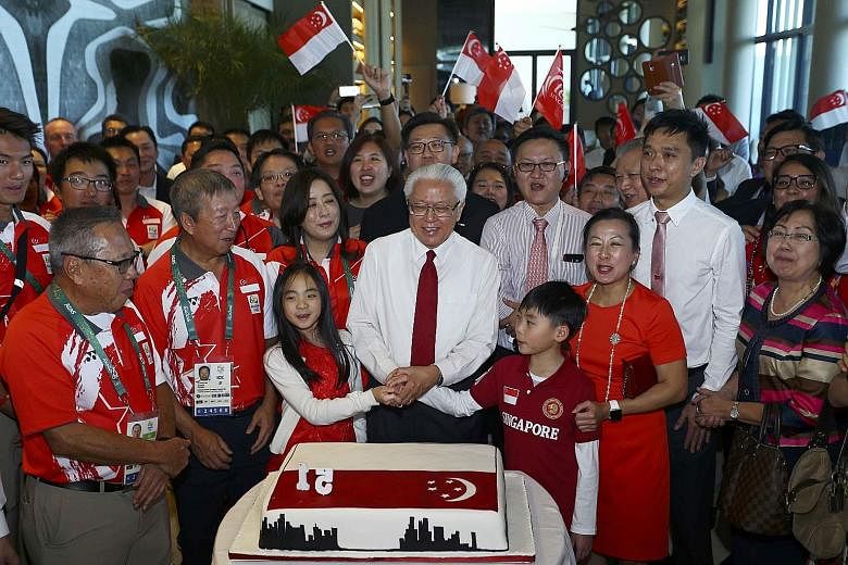 Front row from left: Singapore's Olympic chef de mission Low Teo Ping, International Olympic Committee executive board member Ng Ser Miang and President Tony Tan celebrating Singapore's 51st birthday with the Olympic athletes and other guests at the 