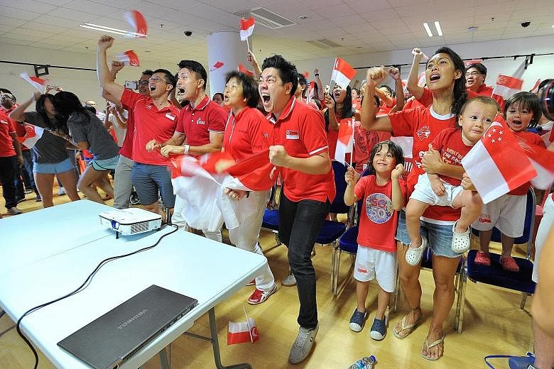 Members of Singapore's sporting fraternity celebrating at the OCBC Aquatic Centre during a screening of Joseph Schooling's 100m butterfly race at the Rio Olympics. His unprecedented victory has captured the imagination of the nation and may inspire m