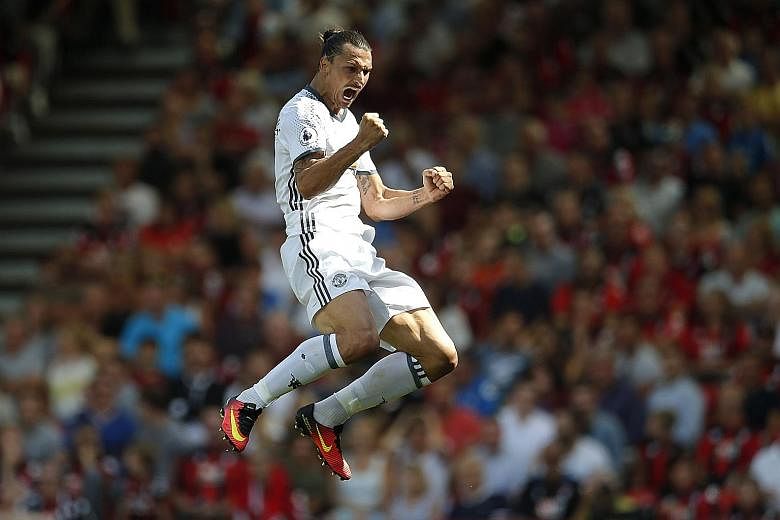Manchester United striker Zlatan Ibrahimovic celebrating after marking his Premier League debut by scoring his side's third goal in their 3-1 win over Bournemouth.