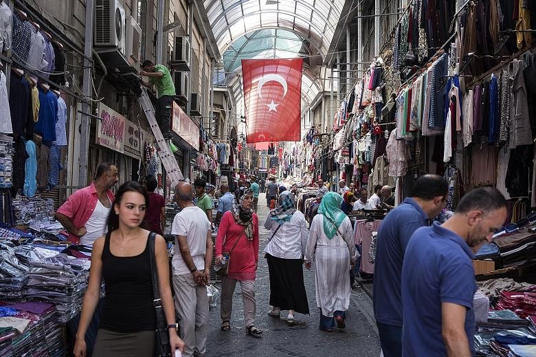 Shoppers browsing in an arcade in the Mahmutpasa district of Istanbul, Turkey, last week. Despite global perceptions, there is no disruption to daily life there. Only critical buildings and the airport have beefed up security checks.