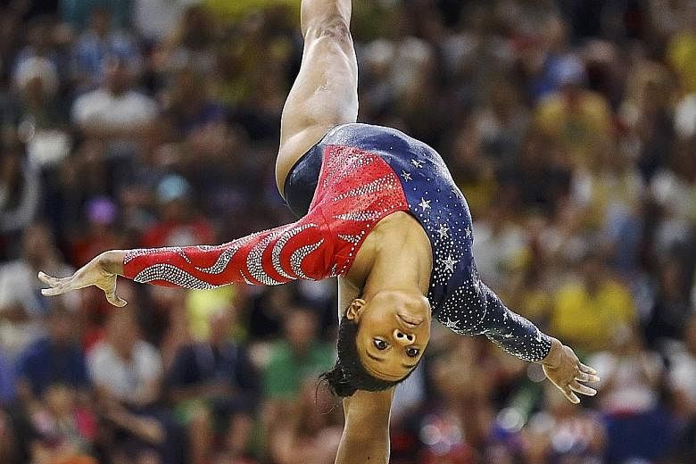US gymnast Gabby Douglas performing at the 2016 Rio Olympics. In the run-up to the London Games in 2012, it was said that her mother had filed for bankruptcy, brought on partly by the high cost of the gymnast's training.
