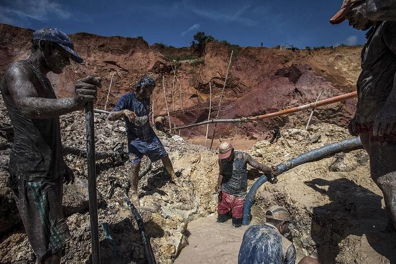 Workers at an illegal gold mine outside Las Claritas, Venezuela. At least 70,000 people have flocked to mines, both legal and illegal, over the past year. As they hunt for gold in the watery pits where mosquitoes breed, they are catching malaria in t