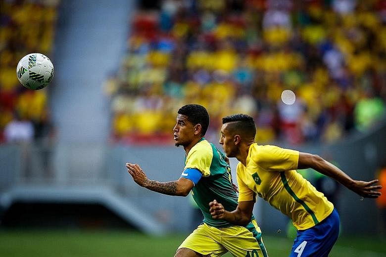 South Africa's Keagan Dolly (left) in action against Brazil's Marquinhos in an Olympic match in Brasilia this month.