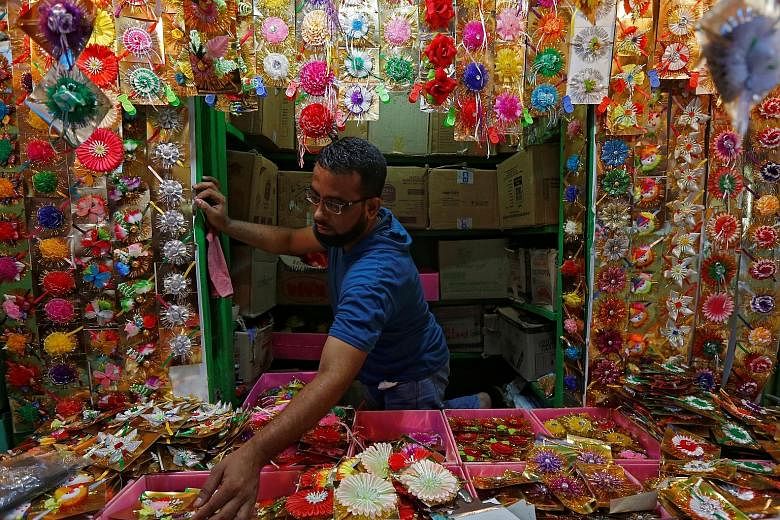 A man arranging "rakhis" or sacred threads yesterday as he waits for customers at his roadside stall in Kolkata, India, ahead of the Hindu festival Raksha Bandhan tomorrow. During the festival celebrating the bond between brothers and sisters, a woma