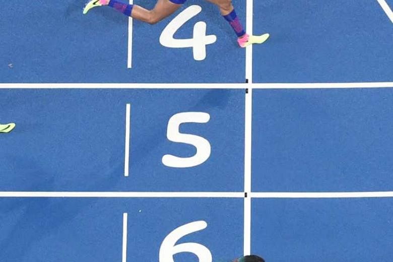 Shaunae Miller dives to cross the finish line, winning the 400m by just .07sec ahead of American favourite Allyson Felix on Monday. It was the Bahamas' first track and field gold medal of the meet, but Felix was left distraught after the narrow defeat.