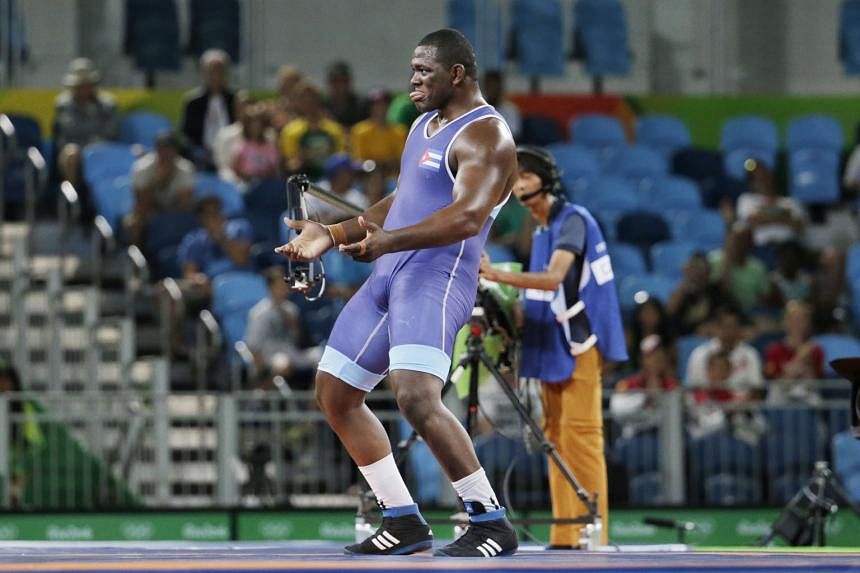 Who said big men can't dance? Mijain Lopez of Cuba, who weighs 130kg, performing an impromptu series of dance moves after defeating arch-rival Riza Kayaalp of Turkey 6-0 in the Greco-Roman super- heavyweight event on Monday. 