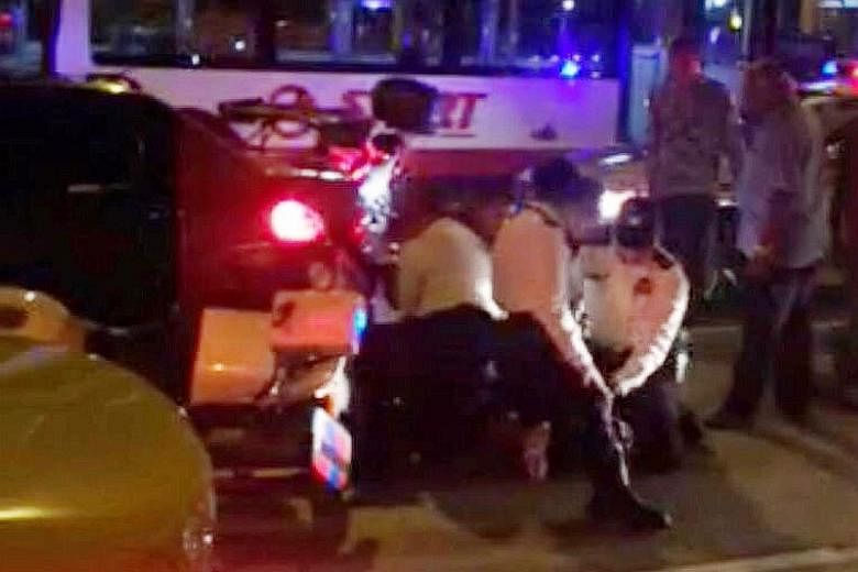 SCDF and police at the scene of the accident (left and below, left) on Tuesday night. The 28-year-old driver put up a struggle and tried to evade arrest. Two police officers were injured in the scuffle. The man was later arrested for drug and traffic