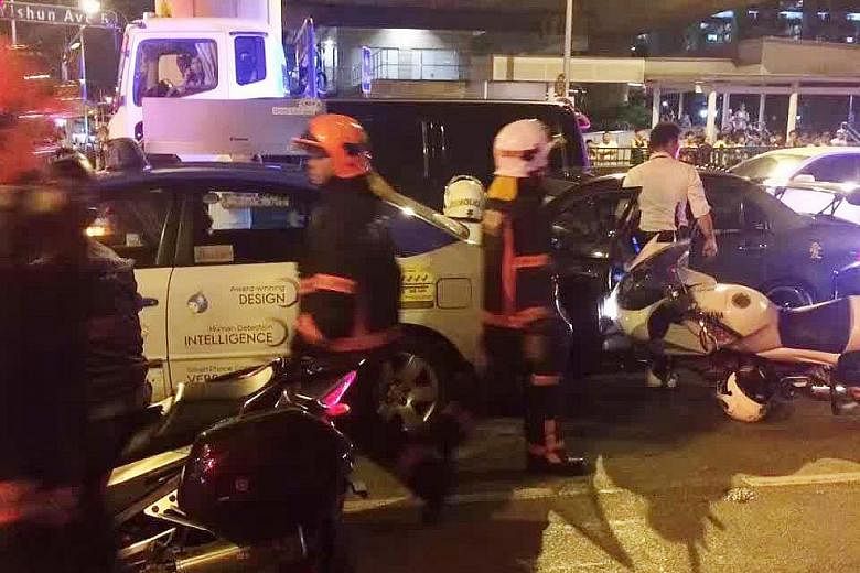 SCDF and police at the scene of the accident (left and below, left) on Tuesday night. The 28-year-old driver put up a struggle and tried to evade arrest. Two police officers were injured in the scuffle. The man was later arrested for drug and traffic
