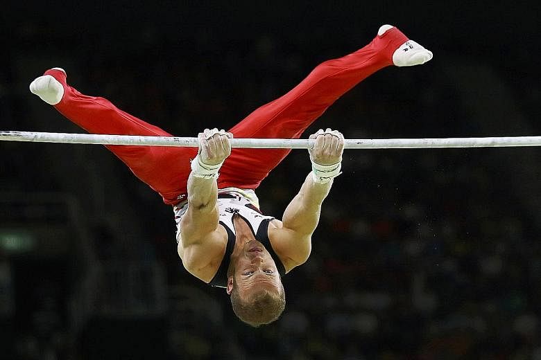 Top: Oleg Verniaiev's victory on the parallel bars was Ukraine's first gold medal of these Games. Germany's Fabian Hambuchen wins the horizontal bar title after finishing third in Beijing and second in London.