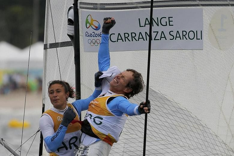 Argentinians Santiago Lange and Cecilia Carranza Saroli celebrating their mixed multi-hull Nacra 17 success. One of Latin America's most legendary sailors, Lange lost a lung to cancer a year ago but bounced back to win his first-ever gold in his sixt