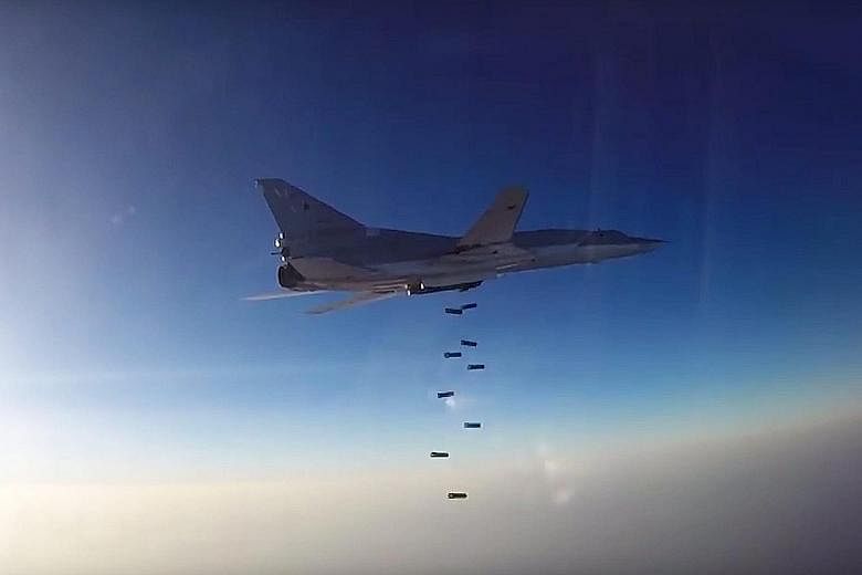 A Russian Tu-22 long-range bomber releasing its payload in Syrian territory after taking off from the Hamadan airbase in Iran. Russia and Iran are staunch backers of Syrian President Bashar al-Assad's regime.