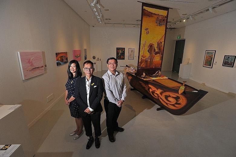 (From left) Singapore Art Museum assistant curator Andrea Fam, the exhibition's artist-in-residence Barry Yeow, and superintendent of prisons Edwin Goh. The boat is the centrepiece of the show and a joint work by inmates from Changi Prison Complex an