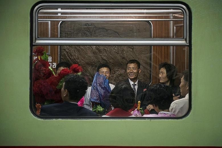 Photographs such as this one depicting North Korea, part of a series titled All The World's A Stage by Scott A. Woodward, will be displayed at MRT stations on the Downtown Line.