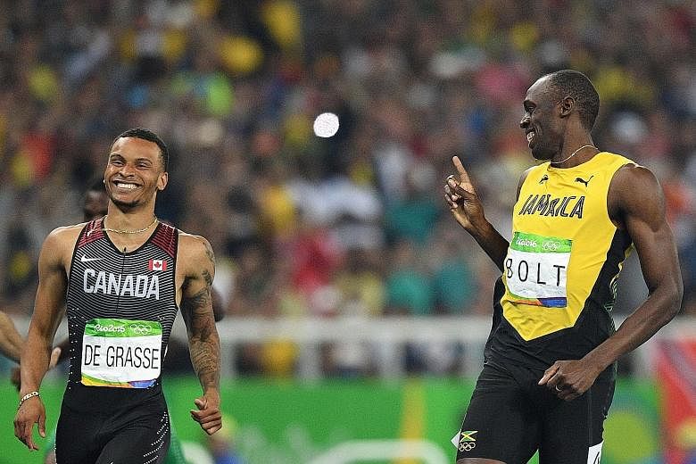 Jamaica's Usain Bolt sharing a laugh with Andre De Grasse as the Canadian made a late attempt to snatch the 200m lead. American Justin Gatlin (in blue) will not be a threat to that record, after failing to qualify for the final.