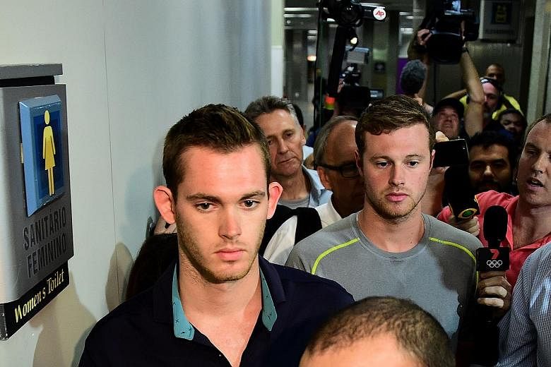Americans Gunnar Bentz (left) and Jack Conger leaving the police station at Rio's international airport. A judge found discrepancies in the swimmers' accounts of the robbery and had ordered them to be detained for further questioning.