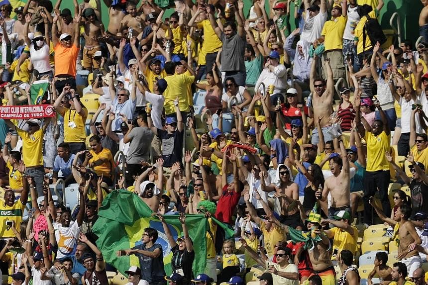 Top: Neymar celebrating his second goal - and Brazil's last - against Honduras. He had also opened the scoring in the 15th second, the fastest goal ever scored at the Olympics. Left: Brazil's supporters had much to cheer at the Maracana on Wednesday.