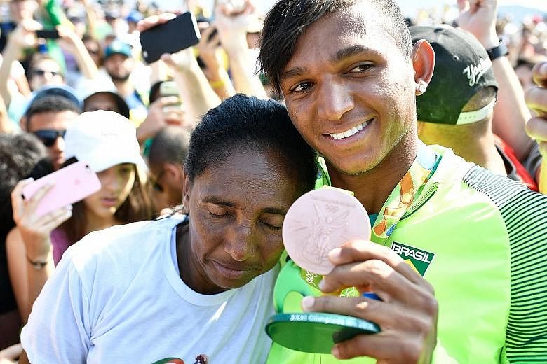 A joyous Isaquias Queiroz dos Santos with his mother Dona Dilma Queiroz after taking bronze in the C1 200m final at the Lagoa Stadium. He earlier won a silver in the C1 1,000m and is going for gold today with Erlon de Souza Silva in the C2 1,000m, in