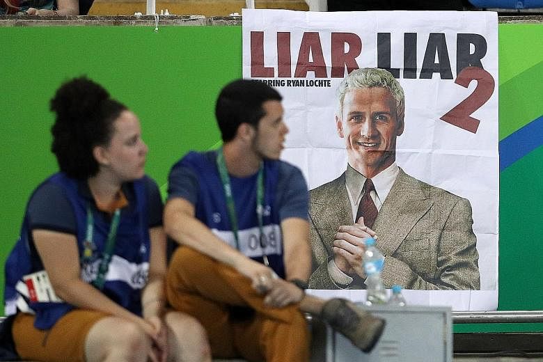 A poster at the Olympic Stadium in Rio superimposing the head of US swimmer Ryan Lochte on the body of actor Jim Carrey, in a mock-up based on publicity material from the 1997 film Liar Liar, about a lawyer who is prevented from lying for 24 hours.