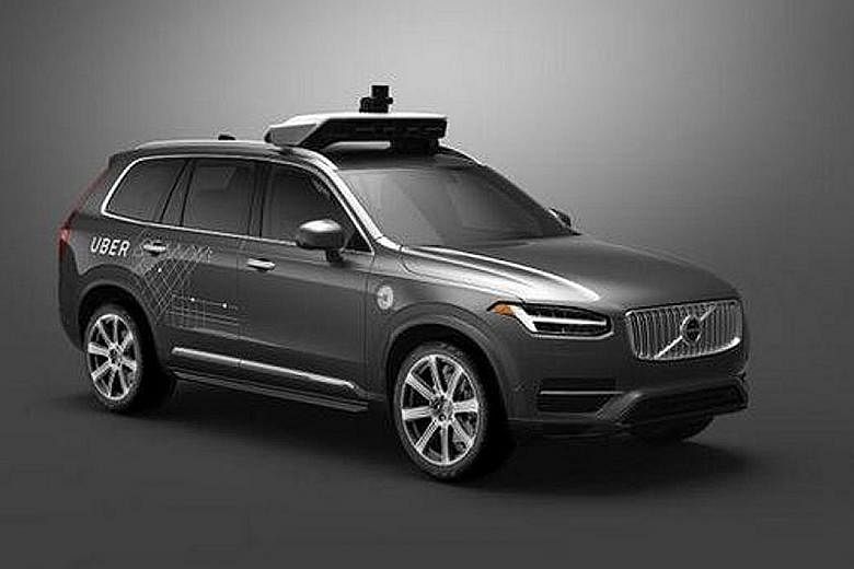 A modified self-driving Volvo SUV that Uber plans to put on the roads of Pittsburgh. It will be the first attempt to commercialise autonomous vehicles. A driver testing a Tesla Model S sedan's Autopilot feature last year. Major car companies have inv