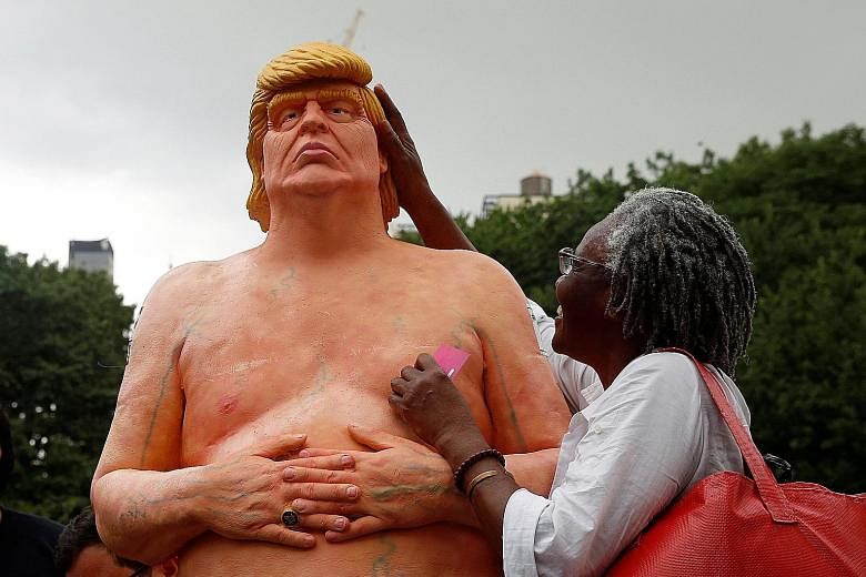 The naked statue of Mr Trump was left in Union Square Park in New York City on Thursday. Park wardens later demolished it. Four other naked statues turned up in Los Angeles, San Francisco and Cleveland.