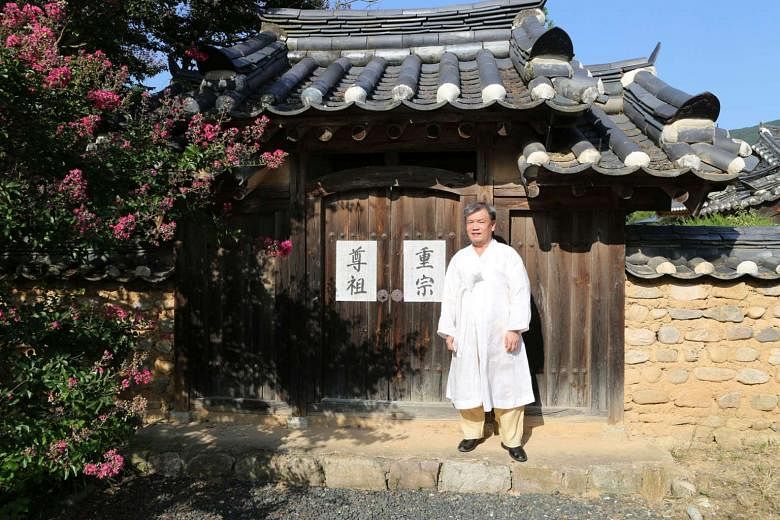 Mr Kim Jung Ki, 62, the eldest grandson of the Andong Kim clan, in front of a shrine in his estate where his ancestors' tablets are kept.