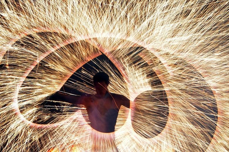 A fire artist performing at the Minsk International Fire Fest in Ratomka, near Minsk, on Friday. The annual festival, which takes place over two days, sees the world's best flame-throwers and pyrotechnic experts gather in the capital city of Belarus 