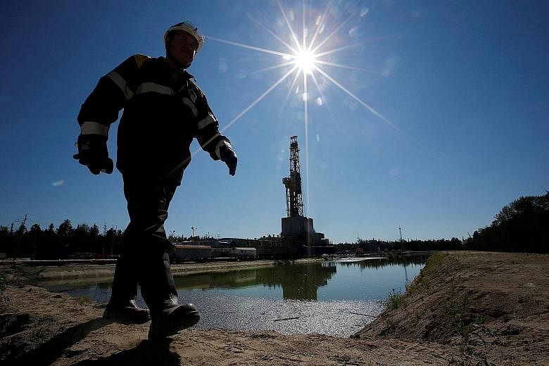 A worker at a drilling rig in an oil field in Russia. Oil prices have surged more than 20 per cent from a low of US$41.80 on Aug 2, on a weaker greenback and speculation of a deal to freeze production when producers meet next month.