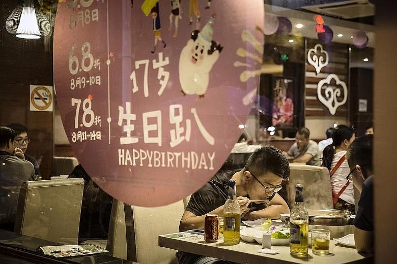 A hot pot restaurant in Shanghai. New guidelines issued in May set recommended weekly intakes for meat, as well as for seafood, at 280g to 525g, or between 14.5kg and 27.3kg a year, a more than 50 per cent drop from the current 63kg of meat consumed 