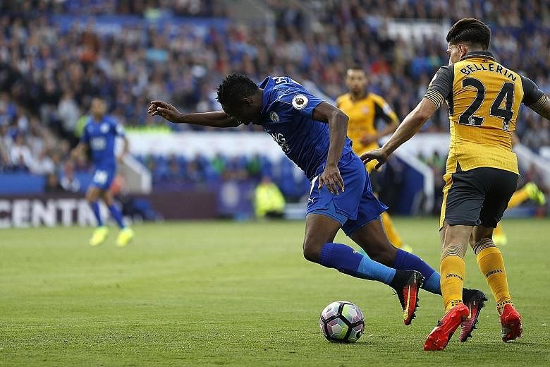 Leicester City's Ahmed Musa going down in the penalty area after a challenge by Arsenal's Hector Bellerin. Referee Mark Clattenburg ignored calls for a penalty, however, as last season's top two sides played out a goal-less draw.
