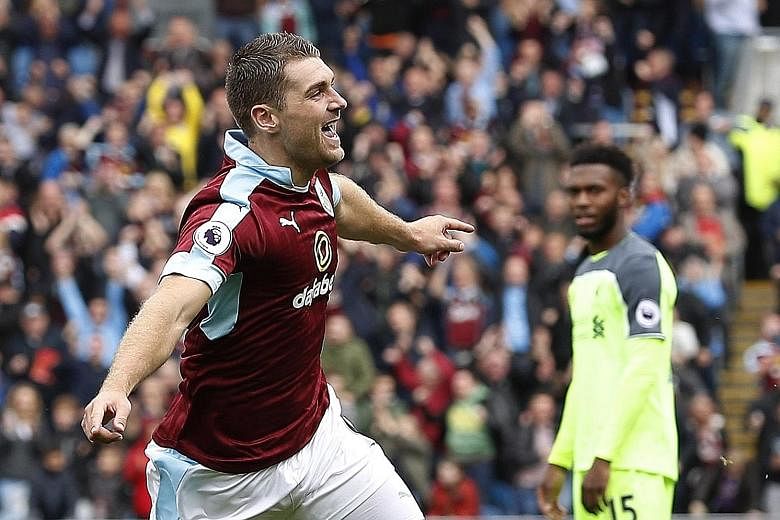 Burnley's Sam Vokes celebrates scoring their first goal against Liverpool. He had been without a Premier League goal in 27 appearances over the past seven years. Burnley won the match 2-0.