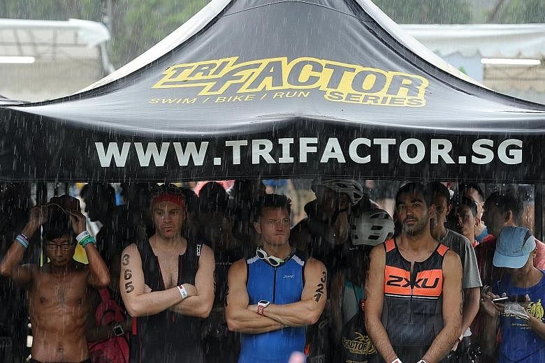 Participants taking shelter under a tent, as they wait for the race to resume following yesterday morning’s heavy downpour, which halted the race for nearly three hours before it was restarted at 10.20am.