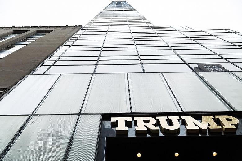 Trump branded merchandise (above) in the lobby of Trump Tower (below) in Fifth Avenue in Manhattan. Mr Trump at the Old Post Office building in Washington, now being developed into a Trump International Hotel under a 60-year lease for which the gover