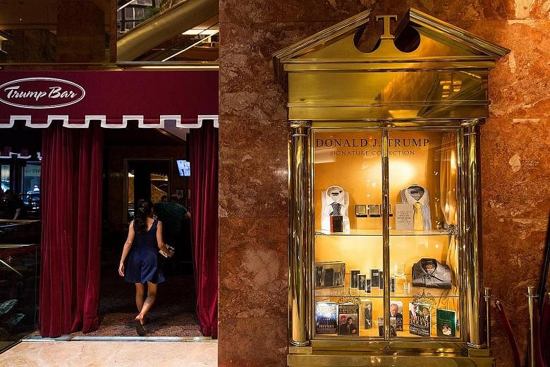 Trump branded merchandise (above) in the lobby of Trump Tower (below) in Fifth Avenue in Manhattan. Mr Trump at the Old Post Office building in Washington, now being developed into a Trump International Hotel under a 60-year lease for which the gover