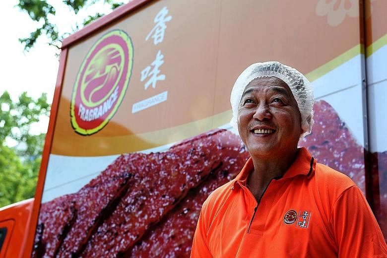 Production line manager Kuah (above) teaches workers to operate machines. His company once took 10 hours to make 1,000kg of bak kwa (left) daily, but now takes just seven hours.