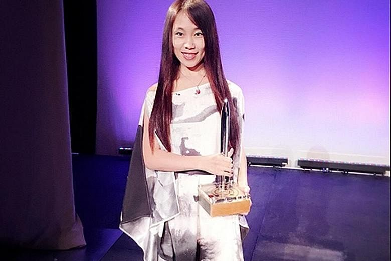 Chinese science-fiction author Hao Jingfang (above) with the Hugo Award for her book, Folding Beijing.