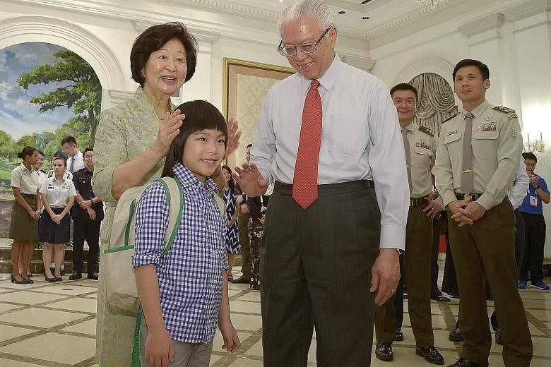 President Tony Tan Keng Yam and his wife Mary with the boy who made heads turn at this year's National Day Parade when he rode a unicorn that appeared to gallop through the air. Minejima-Lee Kai, seven, a pupil of Stamford American International Scho