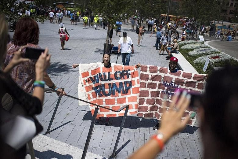 Anti-Trump demonstrators in Cleveland on July 19 reenacting their displeasure with Mr Trump's vow to build a wall on the US-Mexico border to keep Mexican immigrants out.