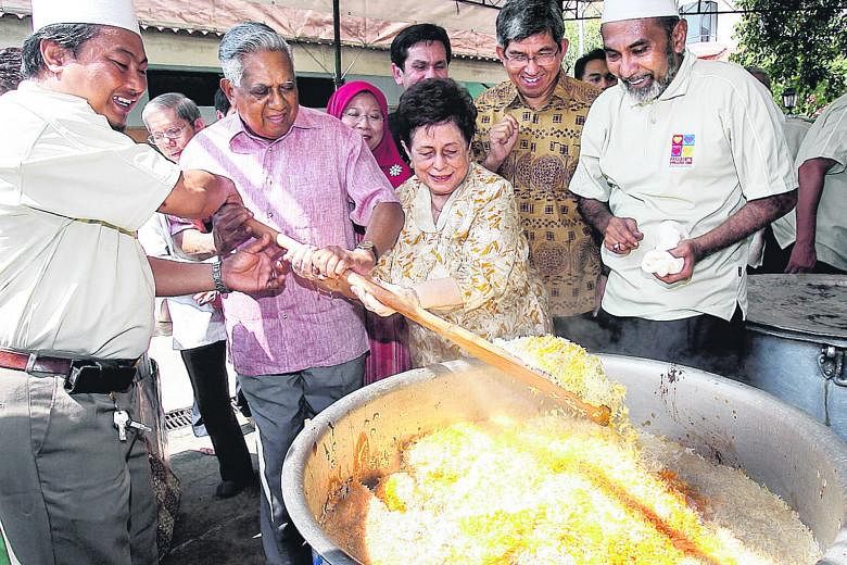 President Nathan and his wife Urmila Nandey stirring briyani rice with the help of a volunteer at a Muis charity event in 2008. The funds raised went to the President's Challenge 2008. Mr Nathan outside his home on Aug 18, 1999, before his nomination
